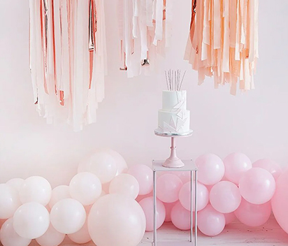 Pair crepe streamer paper with complementary balloons, garlands, and posters